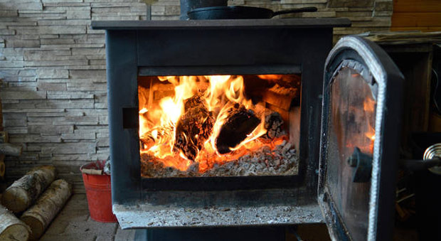 Britons Struggling to Pay Energy Bills Face £300 Fines For Burning Wood to Keep Warm
